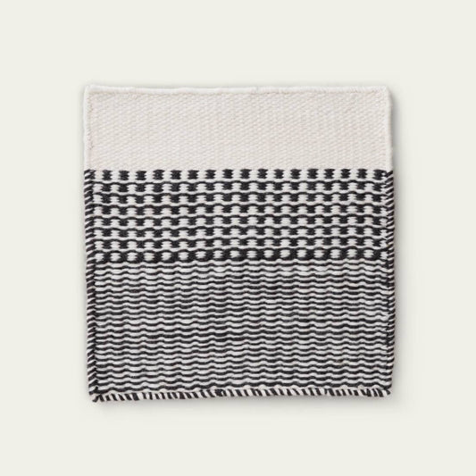 Linear Wool Rug with black and white pattern on a light gray background, #ashblack