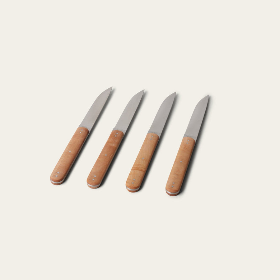 Four knives with brown handles on a light beige background #natural