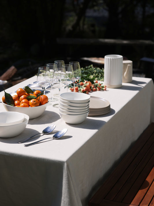 Summer served table with tangerines and flowers