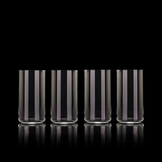 Set of four Fable clear tall highball glasses on a black background