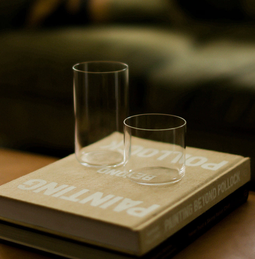 Tall and short glasses side by side on book