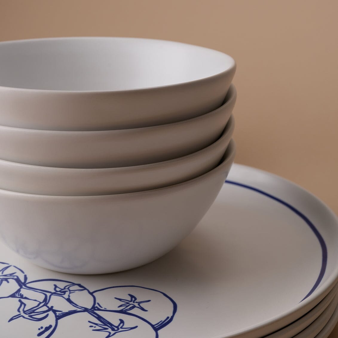 Stack of white bowls with a beige background