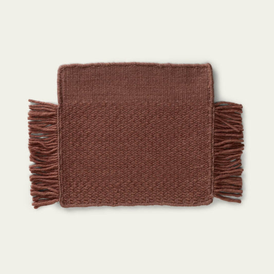 Fringe Wool Rug on a light beige background. #sunsettan