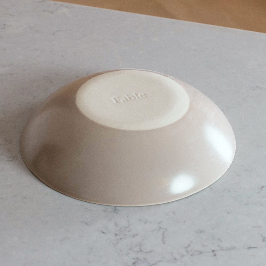 Nested serving bowls dinnerware by Fable Home, shown in a blushpink finish.