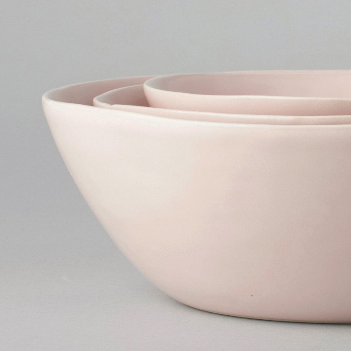 Nested serving bowls dinnerware by Fable Home, shown in a blushpink finish.