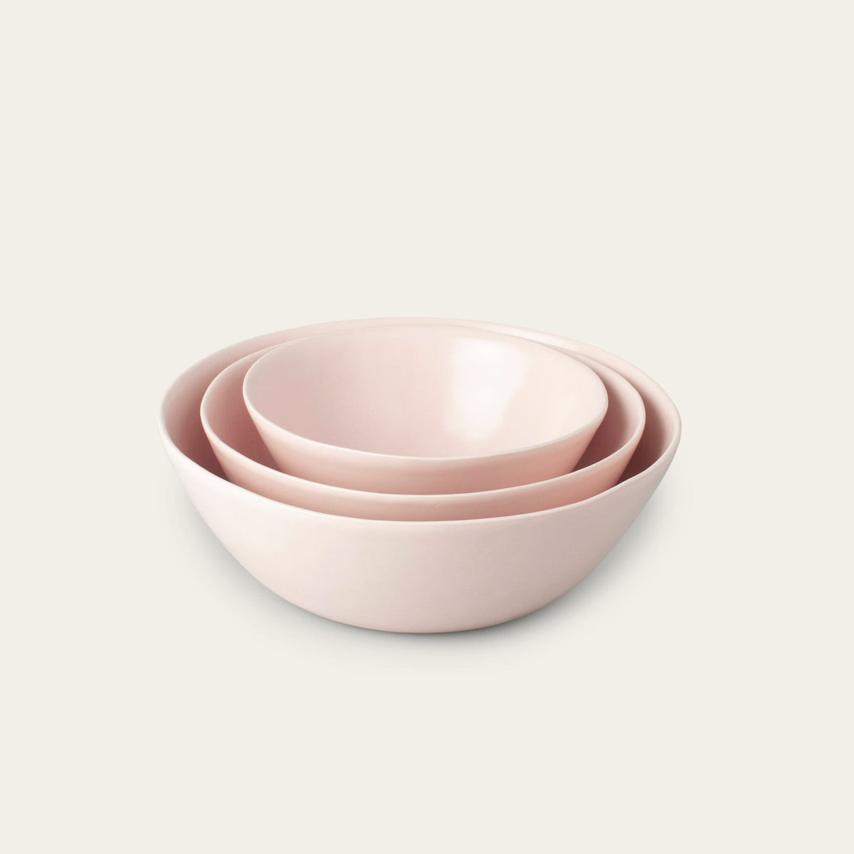 Nested serving bowls dinnerware by Fable Home, shown in a blushpink finish.