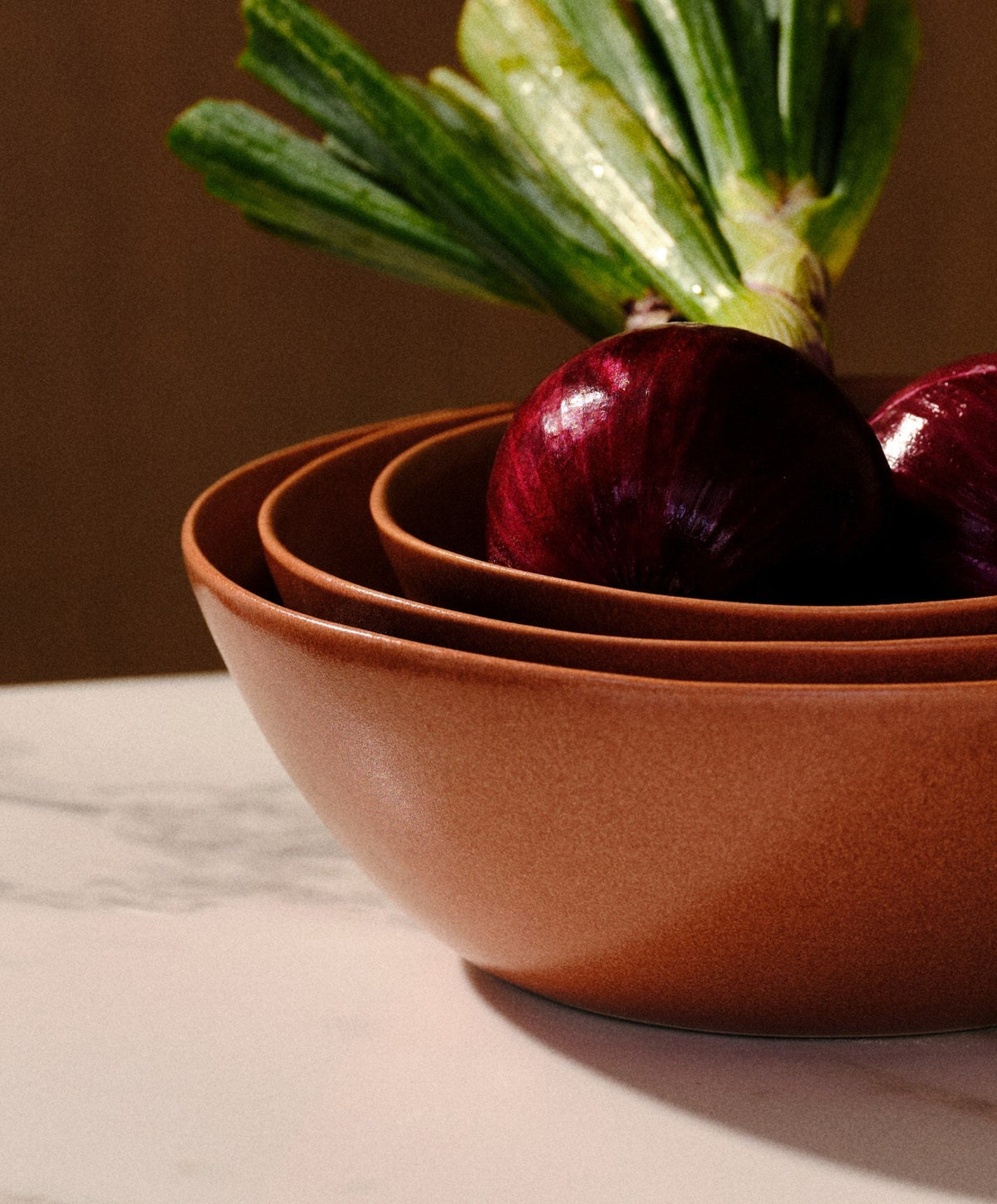 Nested Serving Bowls by Fable Home, shown in Canyon Clay.