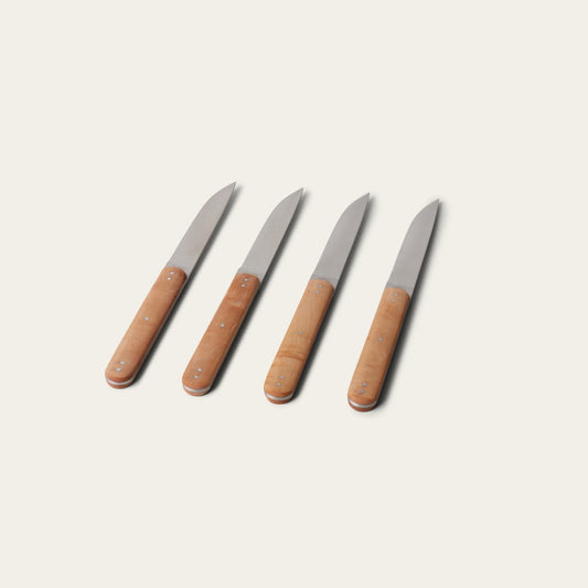 Four knives with brown handles on a light beige background #natural