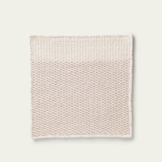 Beige textured rug on a light gray background, #dunegray