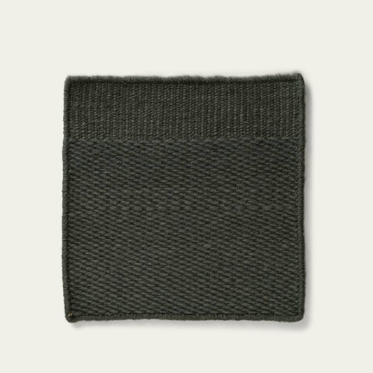 Green textured rug on a light gray background, #forestgreen